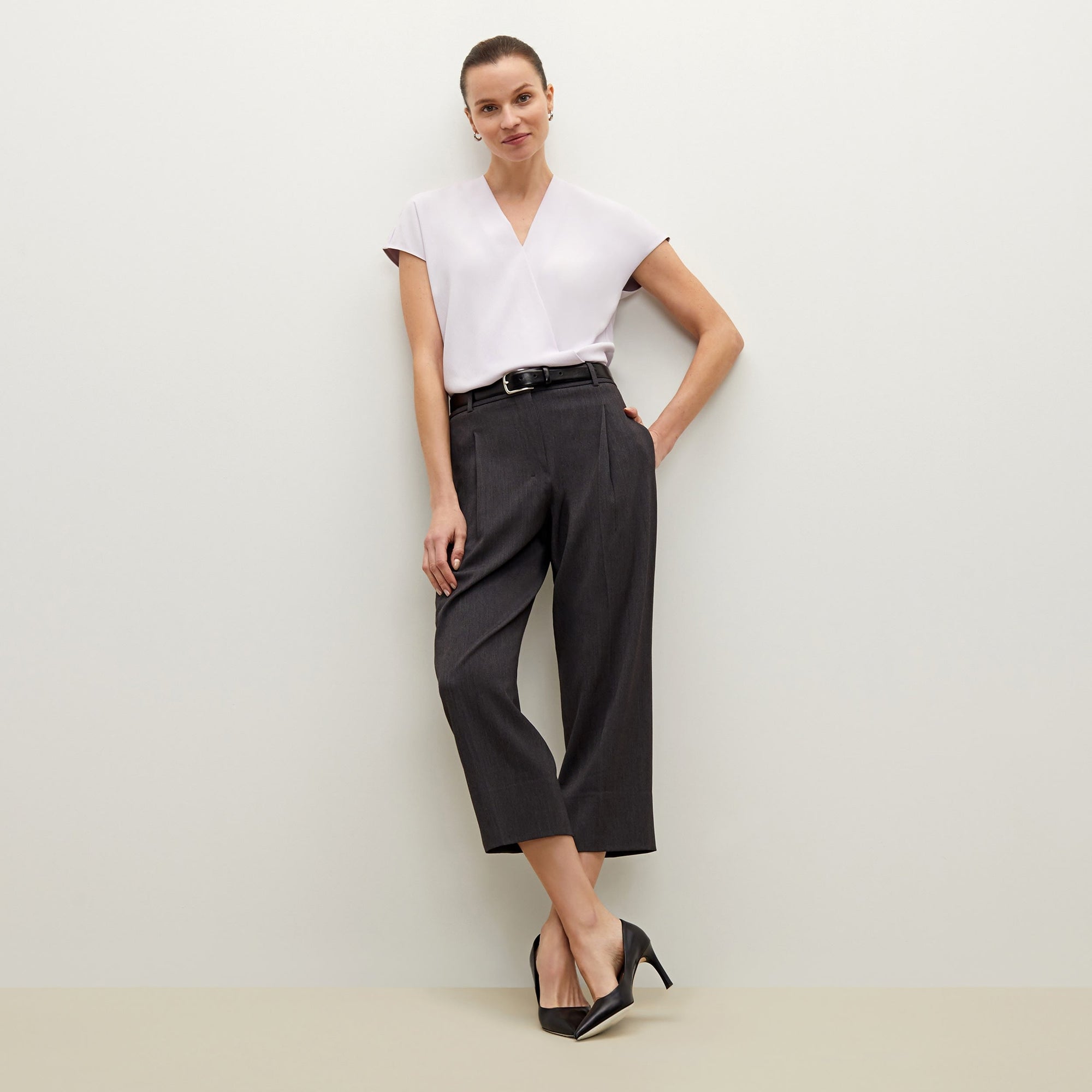 Side image of a woman standing wearing the Isadora pant in charcoal