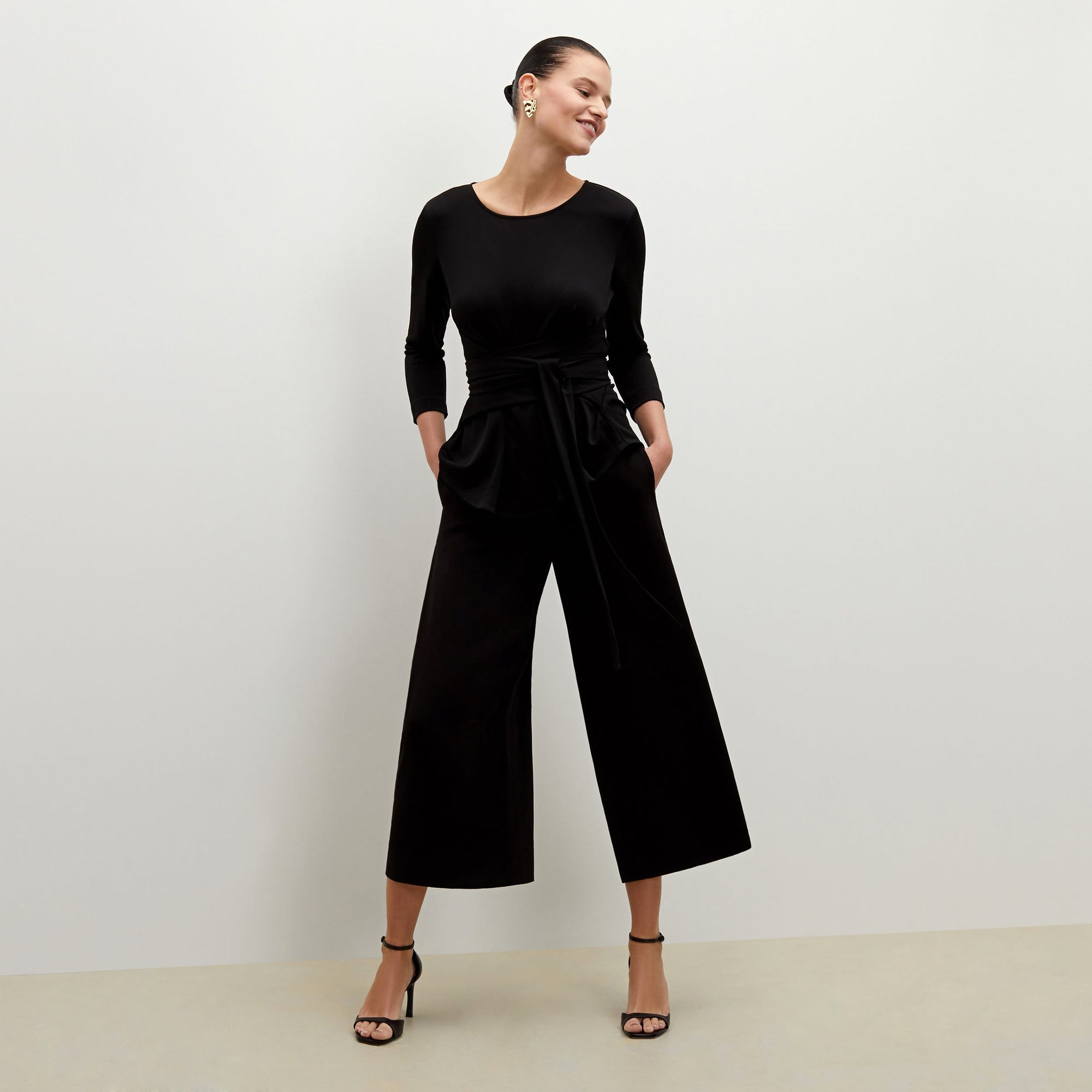 Front image of a woman standing wearing the Zhou culotte in black | Exclude