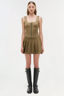 Khaki sleeveless bustier top with front zip closure and pleated skirt bottom, styled with black knee-high boots.