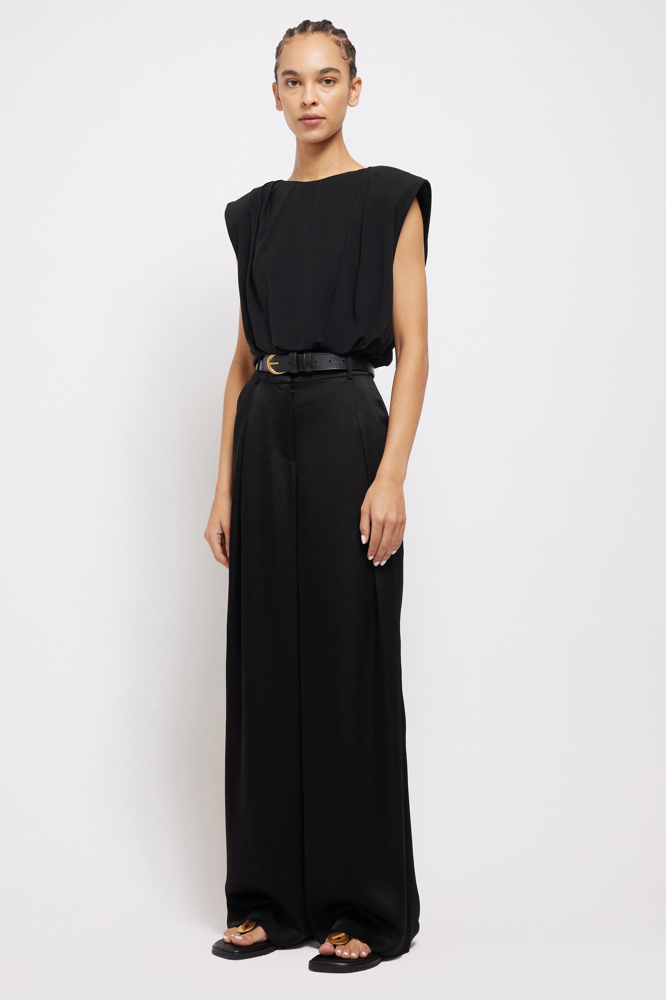 Black wide-leg Mercer Pant with high waist and front pleats, worn with matching sleeveless top and belt.