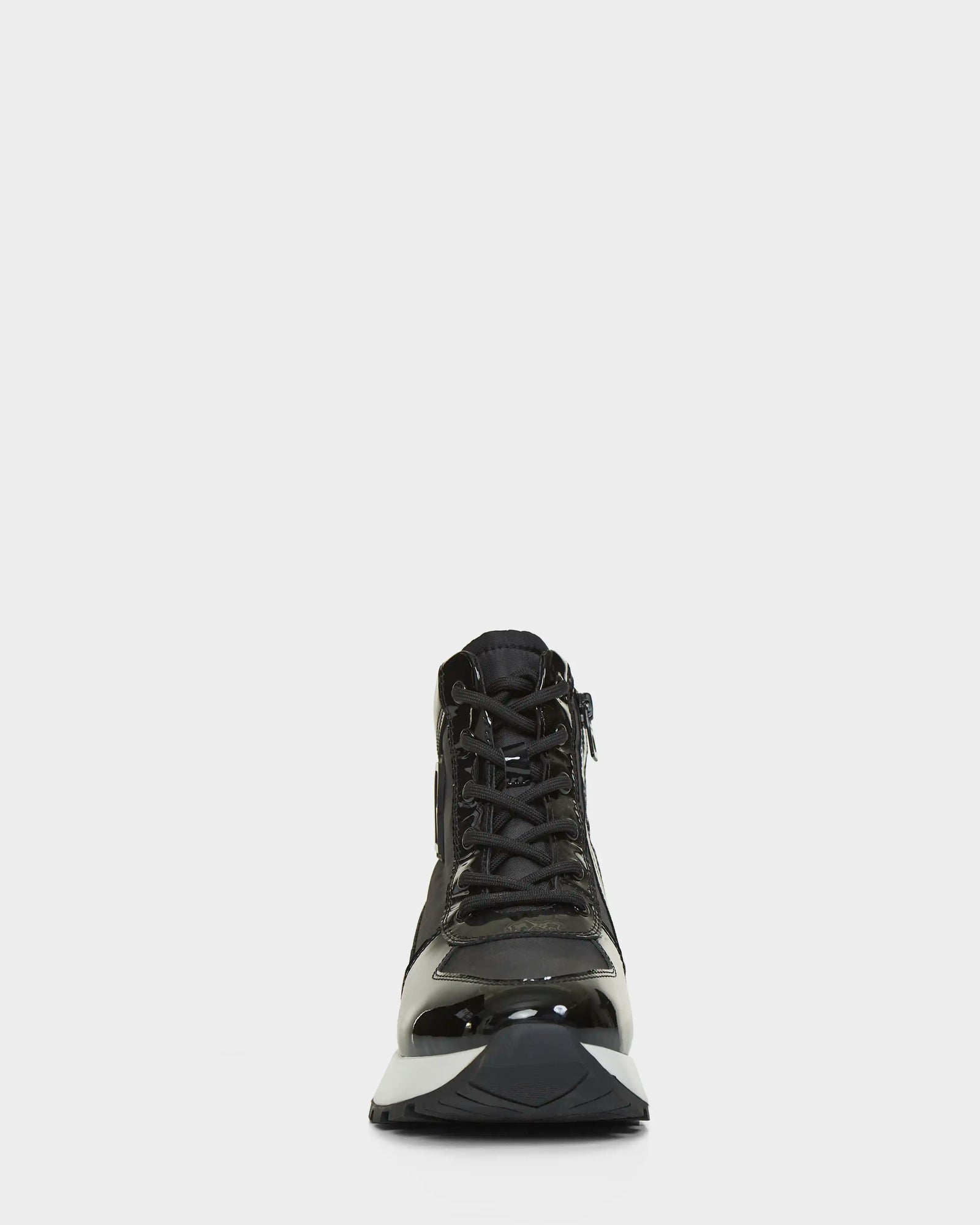 The CHELSA - L223505 Black by Rudsak is a black high-top sneaker with a shiny finish, shown facing forward on a white background. Its neatly tied laces and thick, sturdy sole highlight its sleek, stylish design.