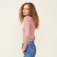 Side view of model wearing the marled sweater long sleeve top in nest.