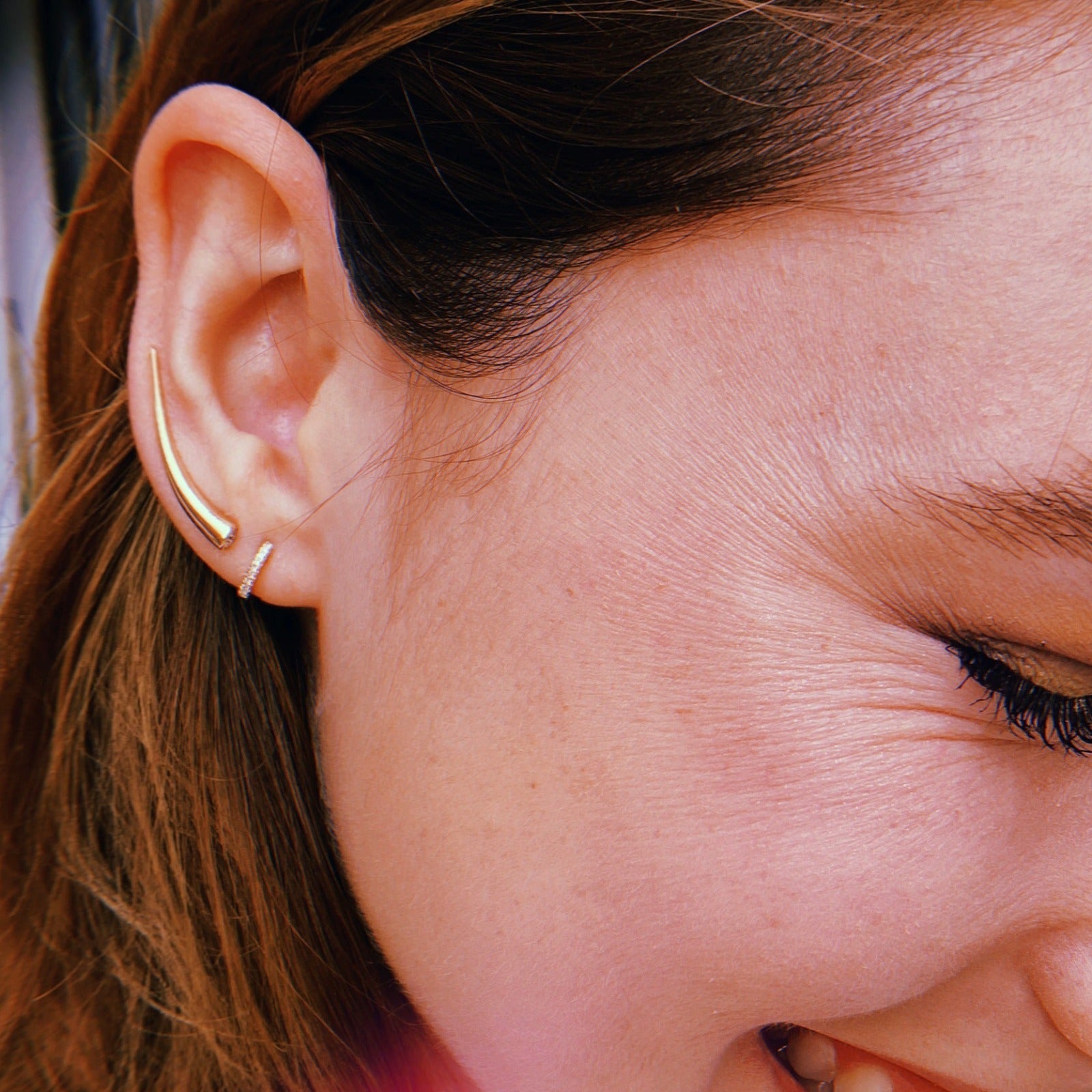 14k gold Curved Quill Climber Earrings styled on an ear