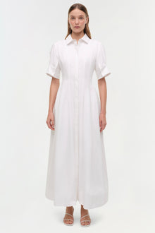 White cotton shirt dress with short sleeves, collar, button front, and ankle-length A-line skirt on model.