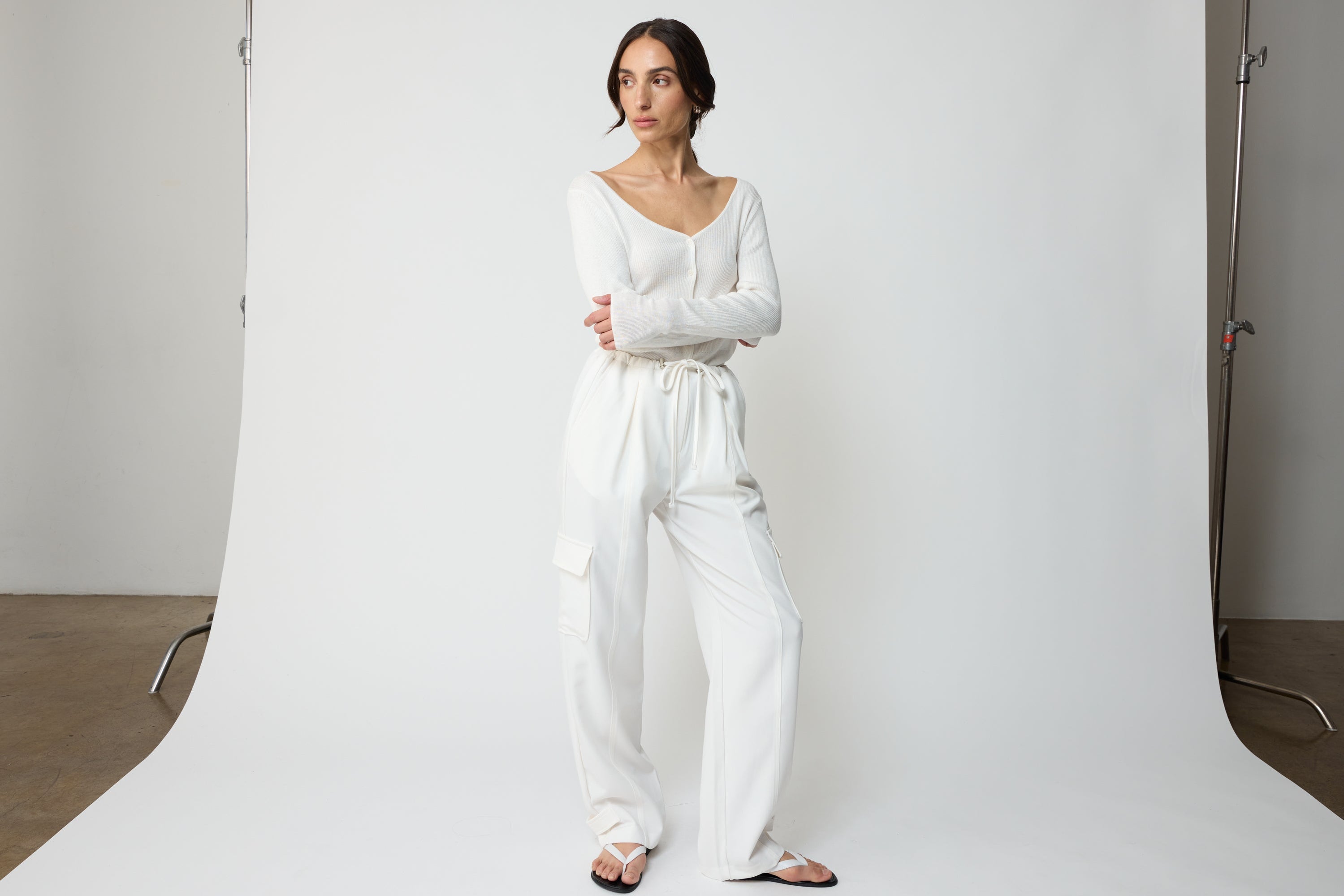 Woman wearing white cargo pants and white sandals