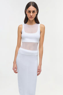 Woman wearing white ribbed sleeveless tank top with sheer mesh panels at neckline and midriff.