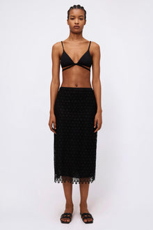 Black textured midi skirt with geometric lace pattern and scalloped hem.