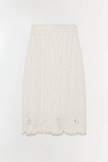 Cream cable-knit midi skirt with distressed hem and cutout details at the thighs.