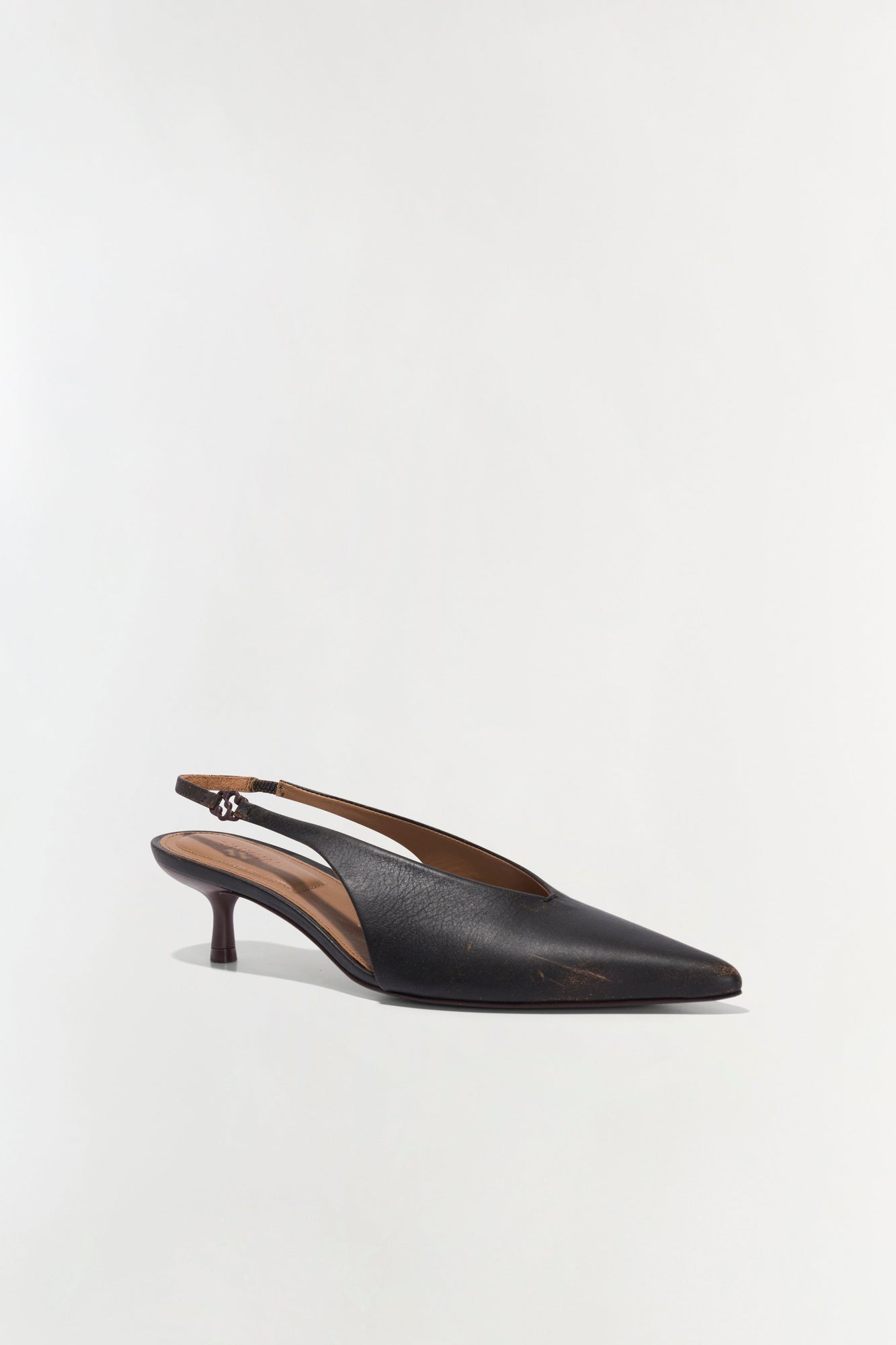 Black leather slingback heel with pointed toe and thin ankle strap.
