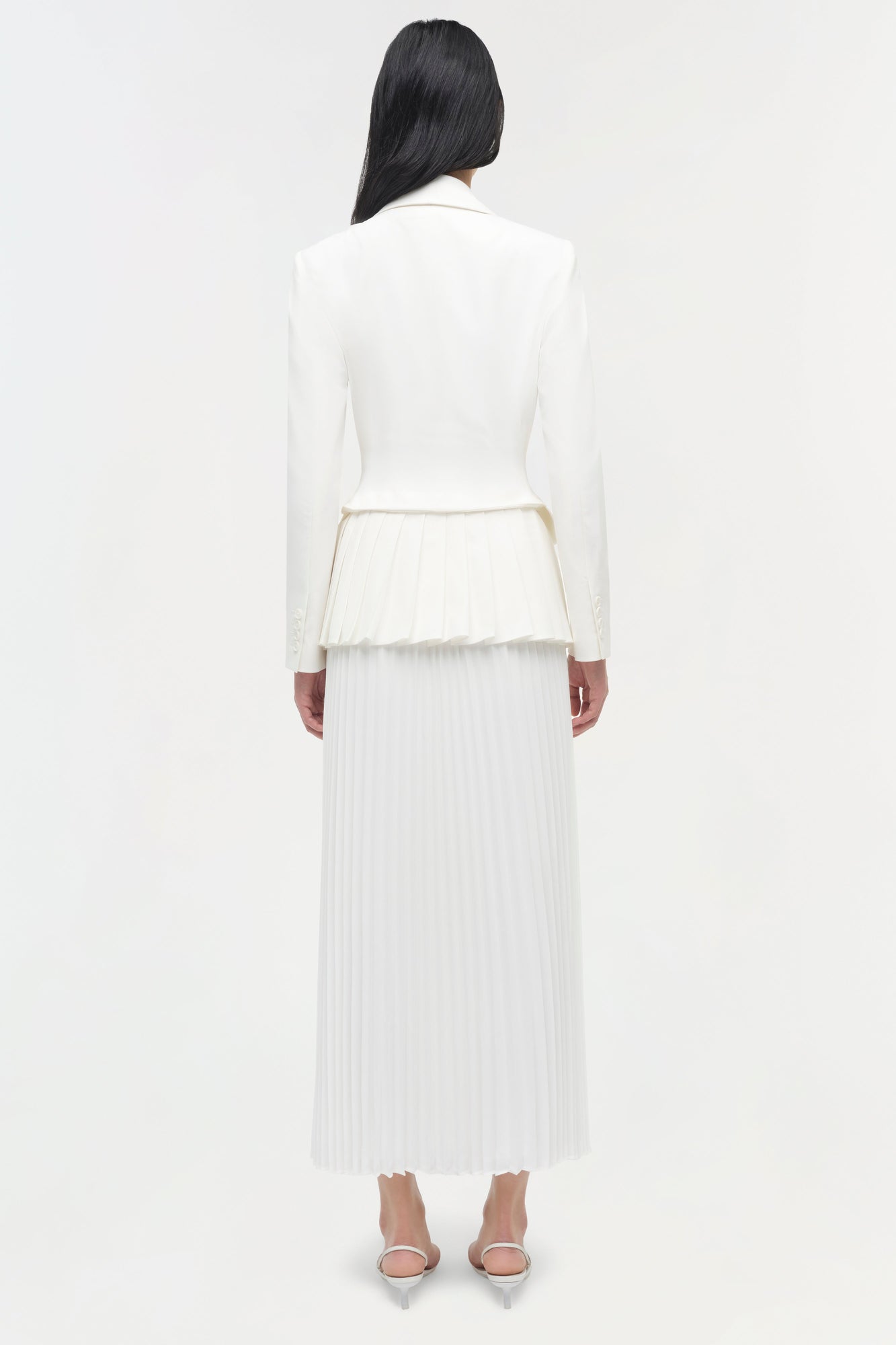 Cream pleated blazer midi dress with long sleeves, shown from back view on model wearing nude heels.