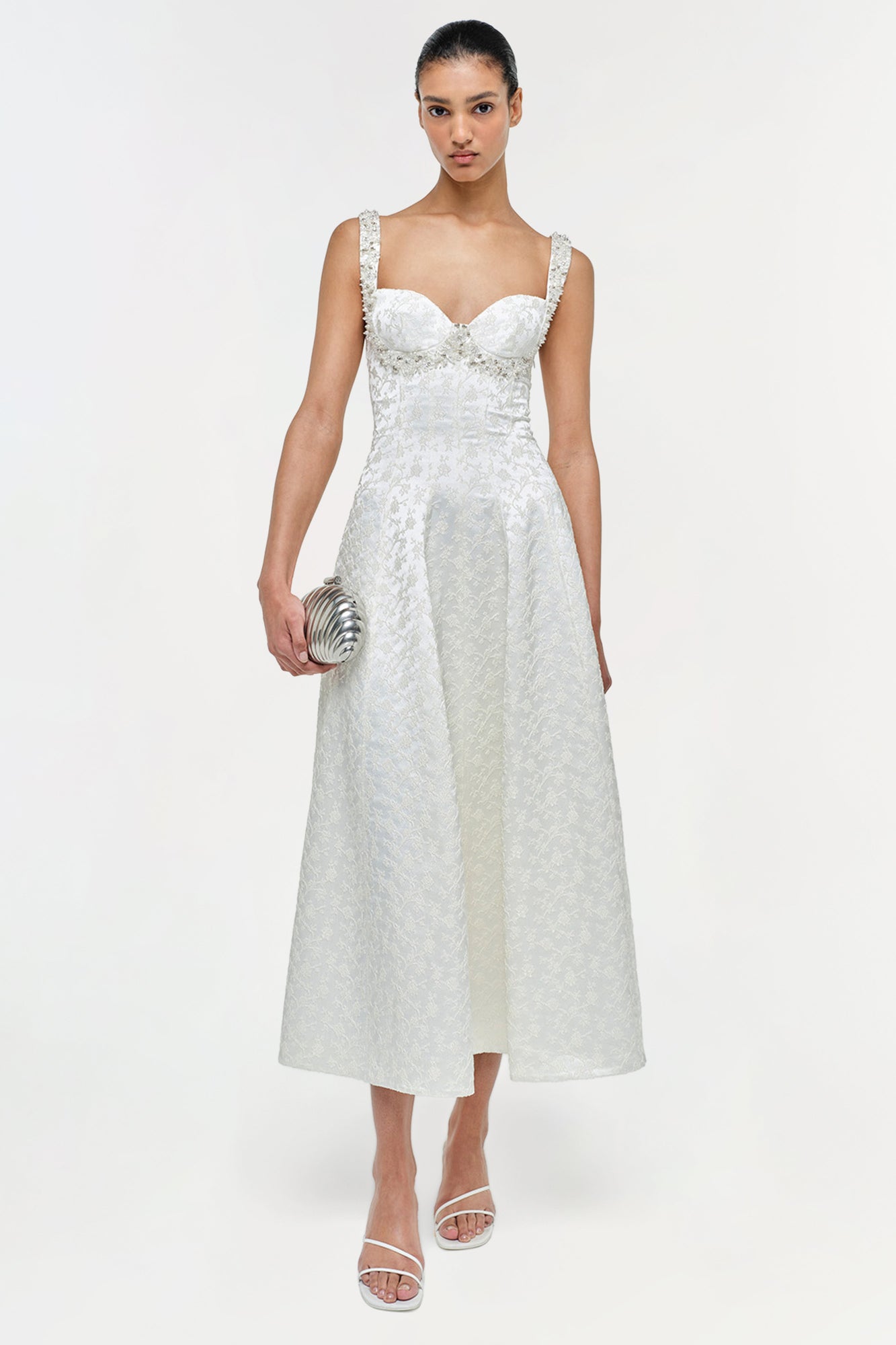 White jacquard midi dress with sweetheart neckline, textured straps, and A-line silhouette on model.