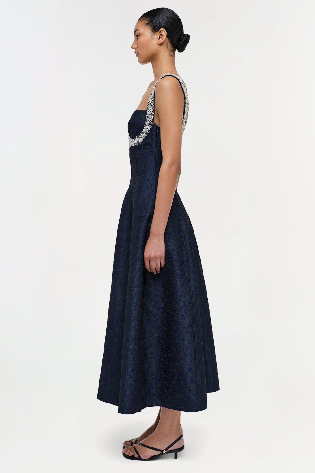 Navy jacquard midi dress with beaded neckline, sleeveless cut, and A-line skirt on model.