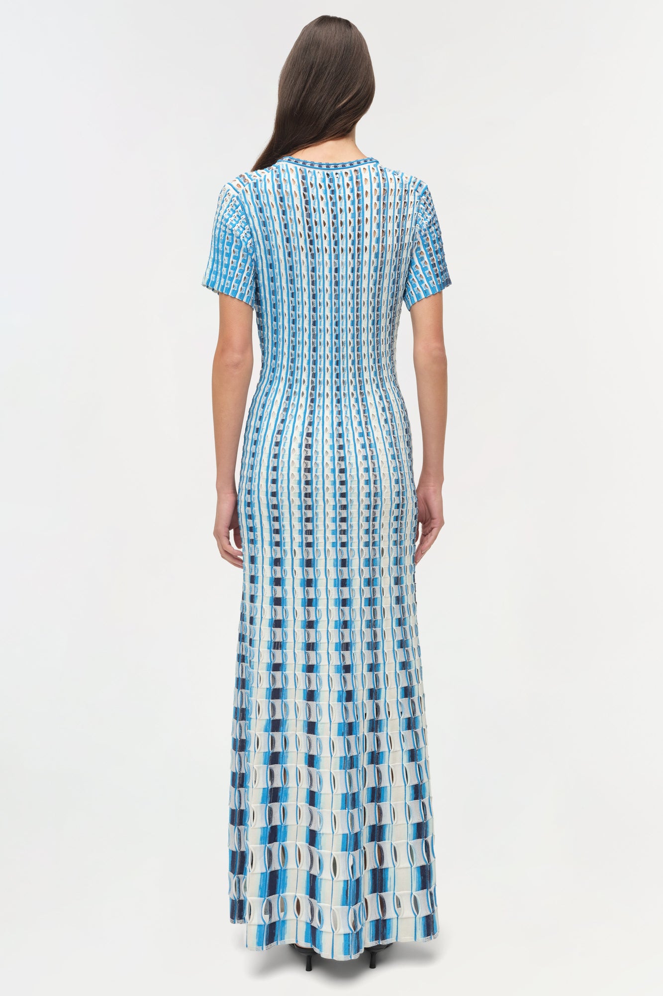 Blue and white eyelet knit midi dress with short sleeves, shown on model from back view.