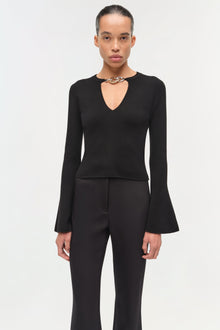 Black wool top with long flared sleeves and a choker neckline with chain detail.