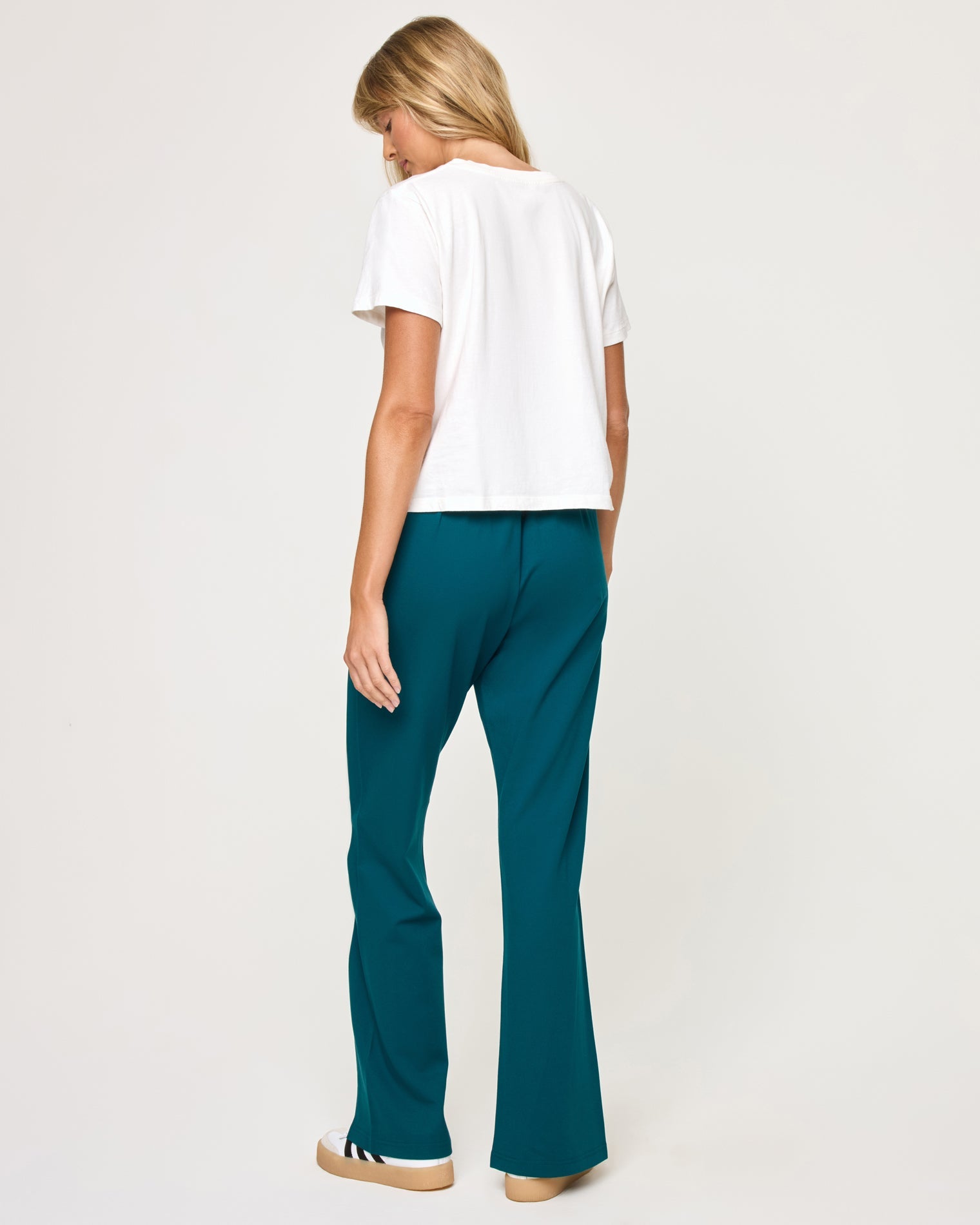 Back view of model wearing the Back To Back Pant in deep teal-cream showing the cream contrast side stripe and wide-leg cut, with matching Back To Back Jacket.