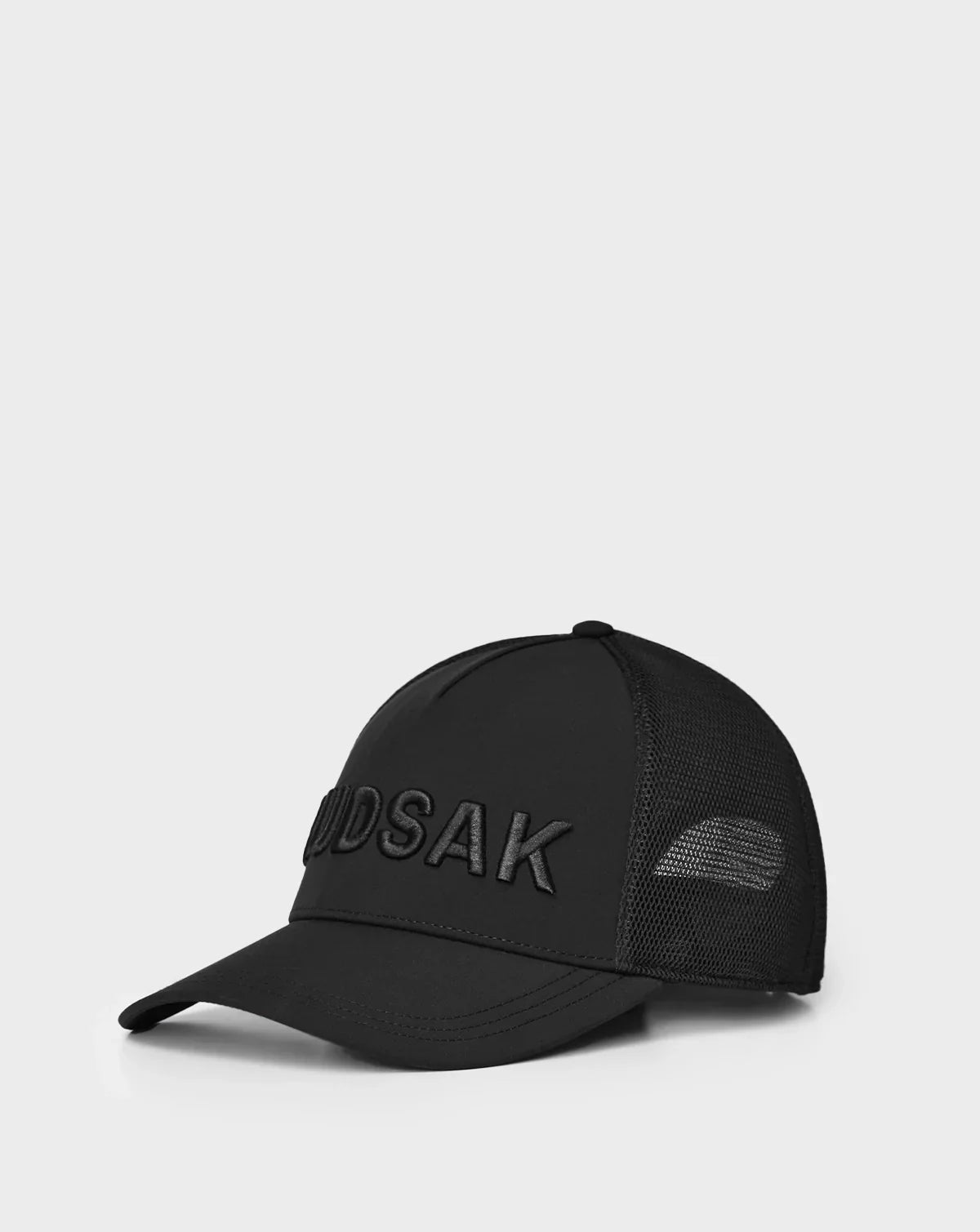 The Rudsak ALFIE - 9424004 Black is a unisex baseball cap with a black mesh back and large MUSDAK embroidery on the front, shown against a plain white background.