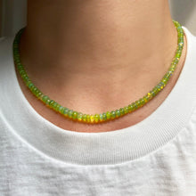 Shimmering Leaf Green Opal beaded necklace made of smooth opal rondels in shades of yellow-green on a slim gold lobster clasp styled on a neck