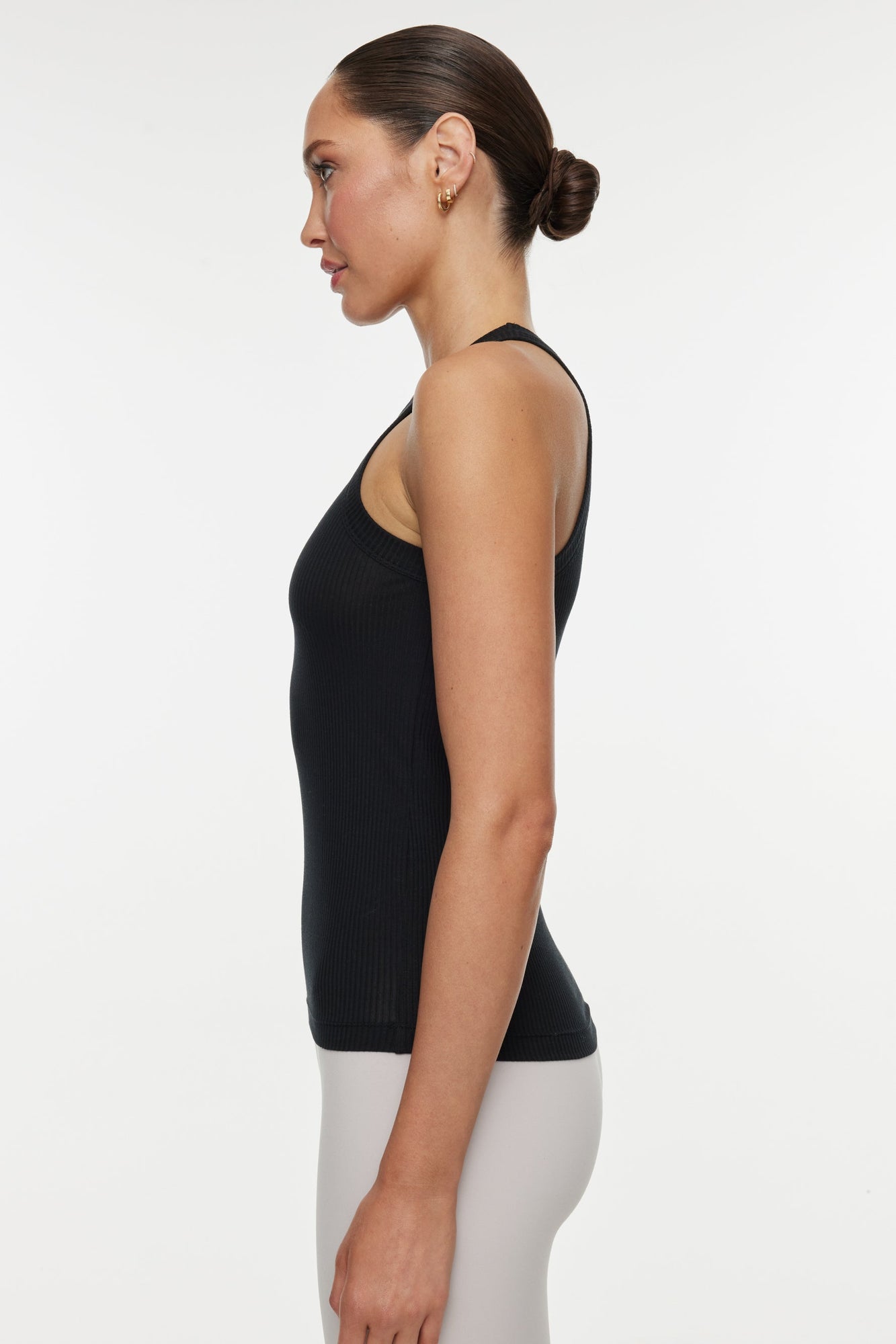 Model wears a high neck black tank. 