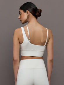 Back view of the Asymmetrical Strappy Bra in Diamond Compression Cloud Dancer with adjustable straps and bonded band.