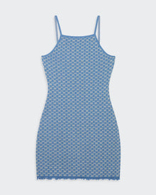 A woman's blue and cream colored checker pattern slip dress with spaghetti straps and a ruffle finish at the hem and cuffs.