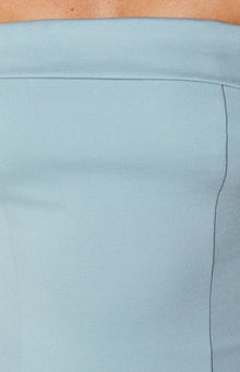 Close-up of the light blue mini dress fabric showing a vertical seam and the folded top edge