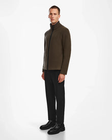 A man faces slightly left, wearing the ARAGON - 6524539 Army men’s fleece full-zip jacket by Rudsak, paired with black pants and shoes, against a plain white background.