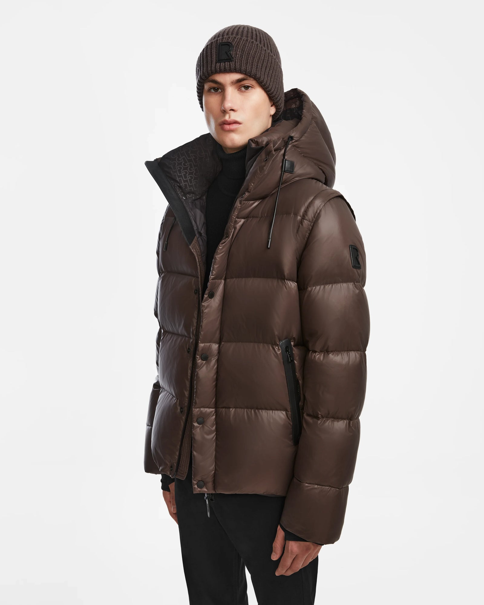 A man wearing the Rudsak BOBBY - 6124506 Espresso 2-in-1 jacket vest and a hat.