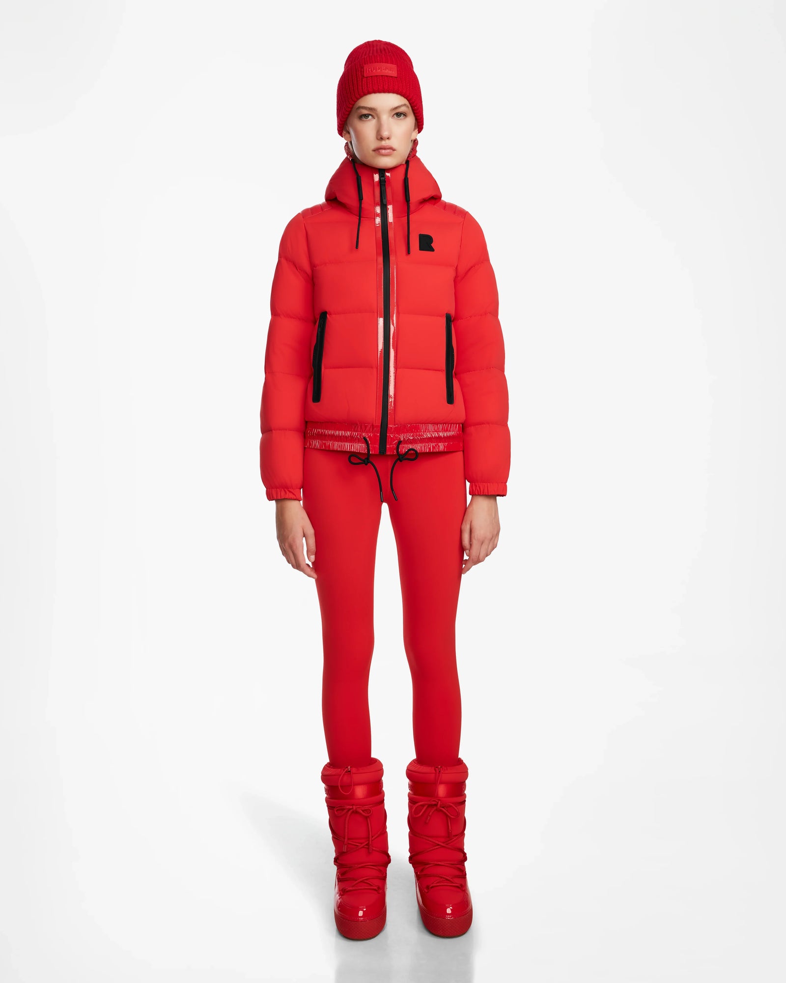 A woman wearing the Rudsak DANI M - 8124539 jacket in Flame Red.