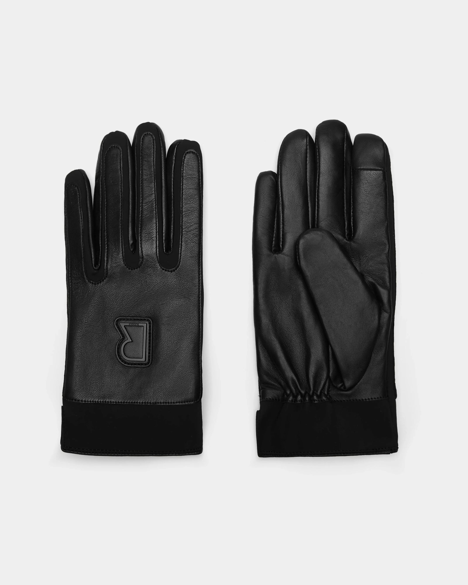 The EDDIE - 6424504 Black mens leather gloves by Rudsak are shown laid flat, one displaying the palm and the other the back with a raised R logo—ideal winter gloves that blend style and warmth.