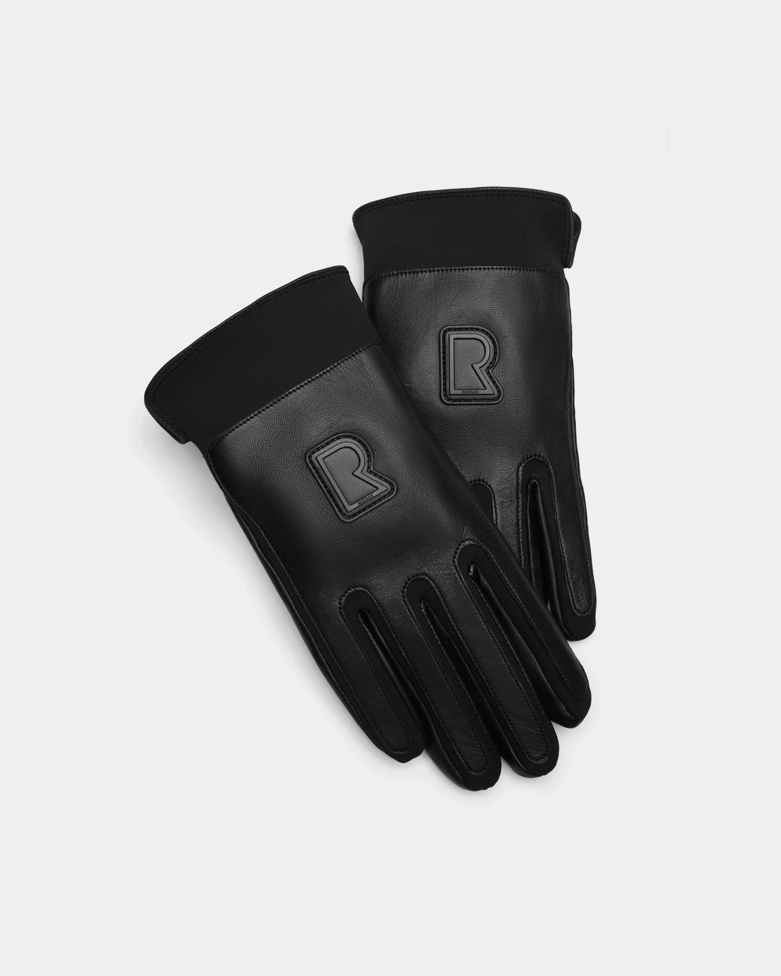 The Rudsak EDDIE - 6424504 Black mens leather gloves feature black cuffs and a raised R logo on each hand, shown against a white background—ideal for stylish winter wear.
