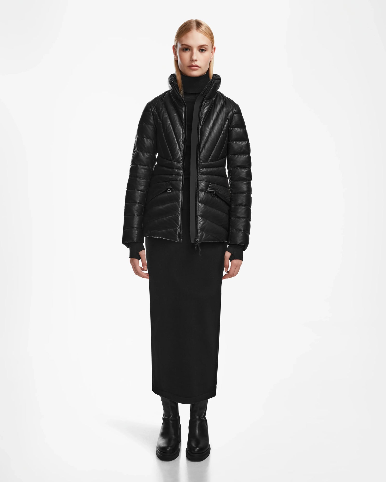 A woman in a sleek black coat, styled in the Rudsak HANNA X - 8123558—a luxury down jacket that elevates any look.
