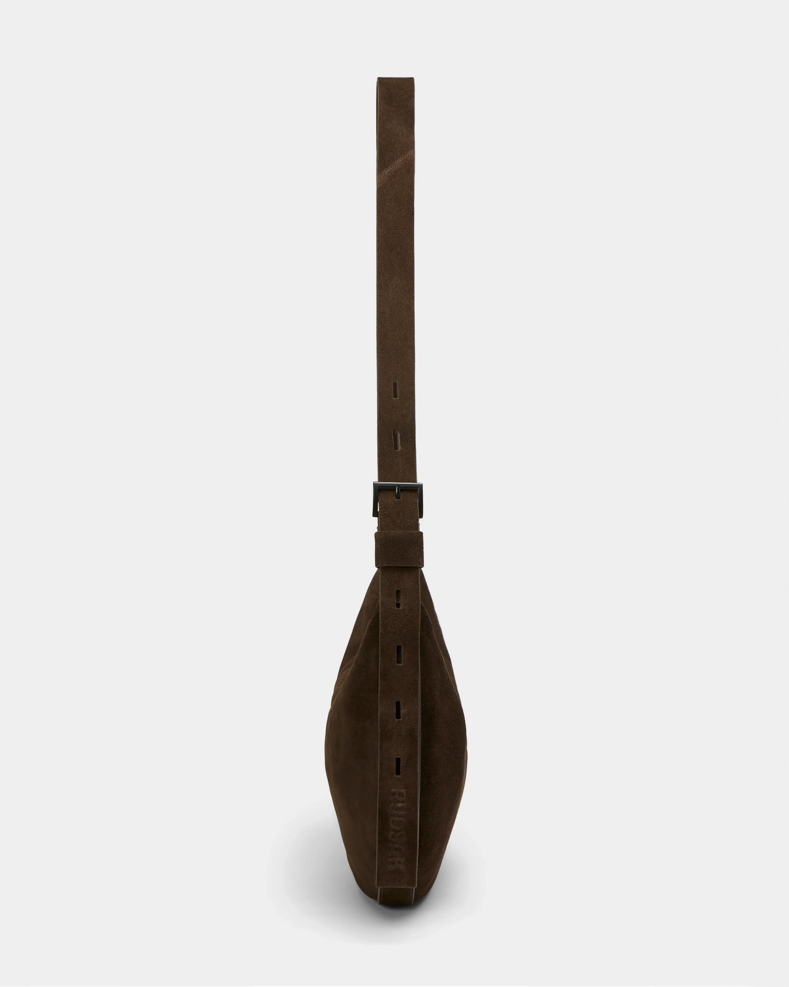 Side view of the Rudsak LANISSA S - 8324520 Espresso brown suede hobo bag, featuring a wide adjustable strap with buckle, shown against a plain light gray background.