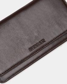 A close-up of the PREYA - 8324508 Espresso wallet by Rudsak, featuring dark brown leather, the Rudsak logo embossed on the surface, and fine stitching along the edges.