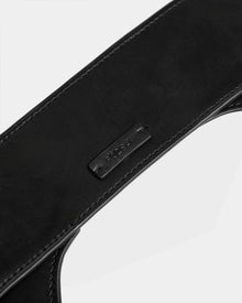 Close-up of a black womens leather waist belt, SIMONA - 8424522 Black by Rudsak, with neat stitching and a small rectangular patch embossed with the brand name. Set against a plain white background.