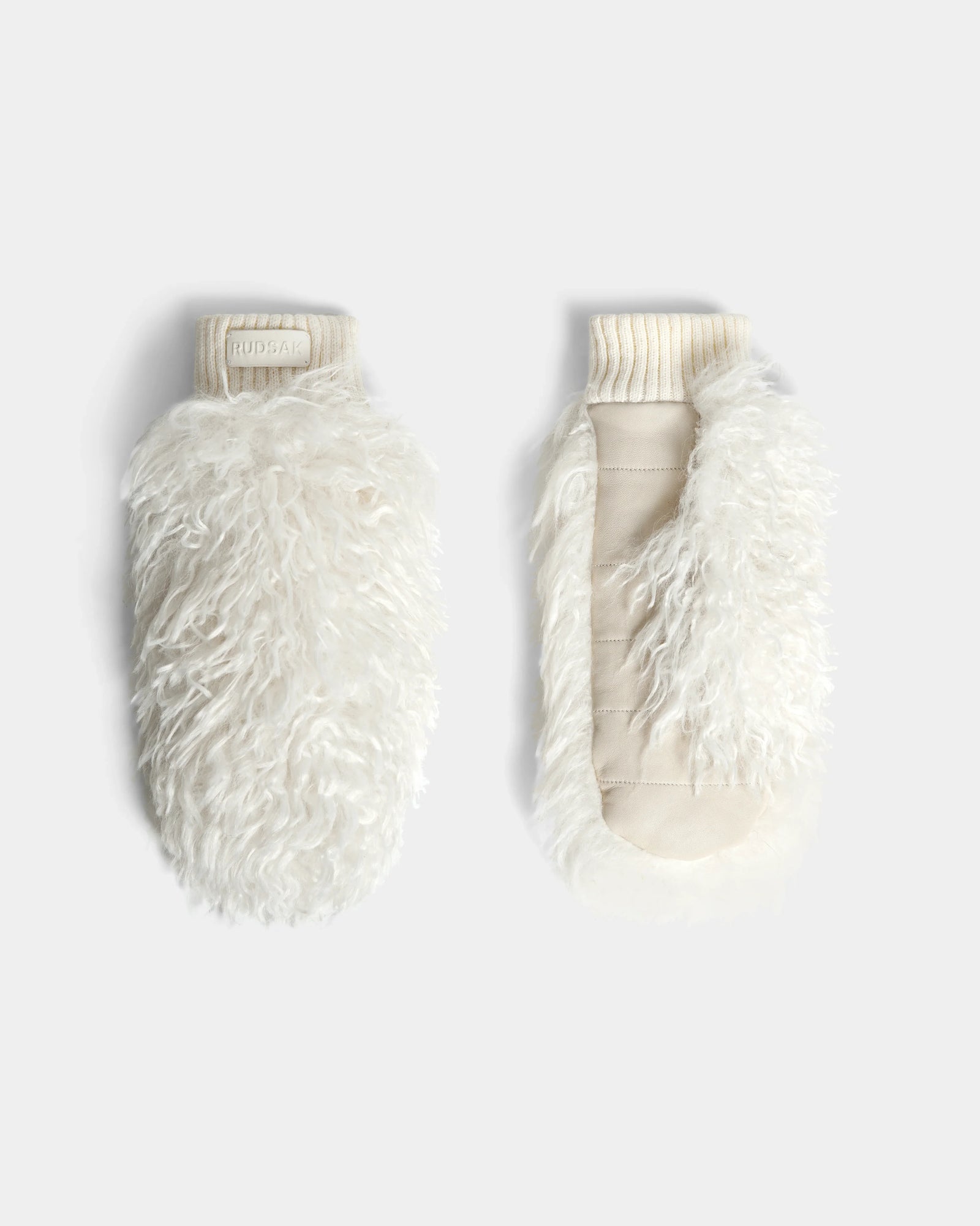 The Rudsak SUSAN M - 8424505 Iceland mittens feature white, fluffy faux Mongolian fur with a shaggy texture and ribbed cuffs—ideal for women’s winter gloves or après-ski style—shown on a light gray background.