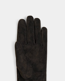 A close-up of the Rudsak FLORA - L425542 Espresso suede women’s glove, palm down on a light grey background, shows part of the winter glove with four fingers and the thumb visible.
