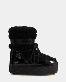The Rudsak KATHY Y - 1224500 Black winter boot features a shiny patent finish, thick rubber sole, fuzzy water-repellent upper, front laces, signature branding, and cozy insulation for a modern moon boot vibe.
