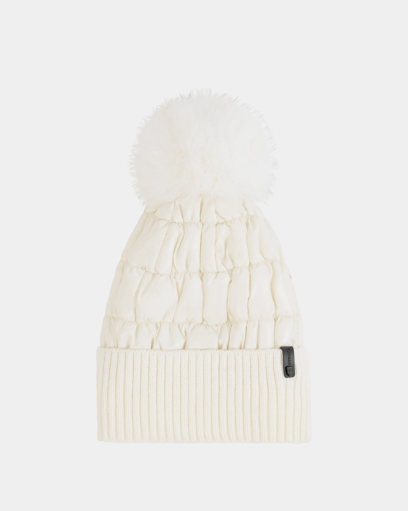 The Rudsak LANYA - L423514 Iceland women's winter hat features a soft wool blend, ribbed fold-over cuff, large fluffy pom-pom on top, and a small black tag attached to the cuff.