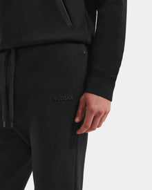 A person showcases the Rudsak MAXTON - U525007 Black M jogger, featuring 