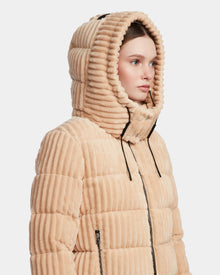 A woman in the Rudsak MIRRY FF - L124507 Iceland light beige women's short down puffer jacket with a large hood up, looking to the side against a plain white background.