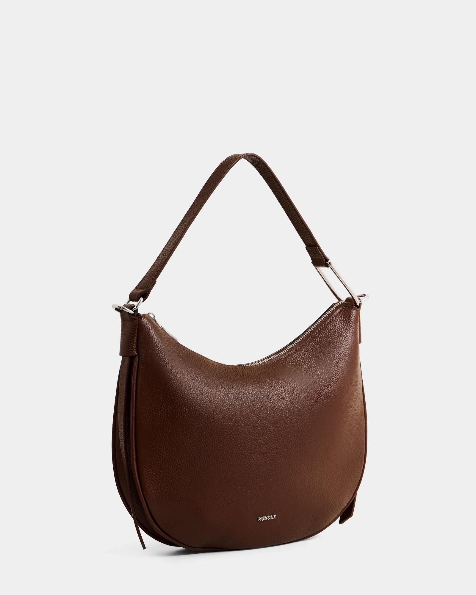 The Rudsak SYLVIA - L325515 Mocha is a brown, crescent-shaped women's leather shoulder bag with a single strap, smooth texture, minimal design, and subtle metallic accents, shown against a plain white background.