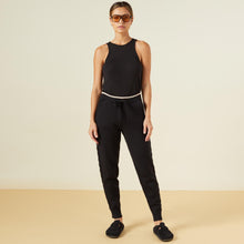 Front view of model wearing the supersoft sweater knit color block sweats in black.