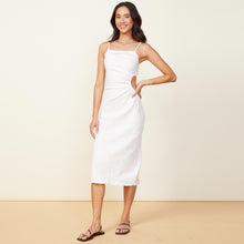 Front view of model wearing the linen slip dress in white.