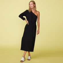 Front view of a model wearing the gauze one shoulder dress in black.