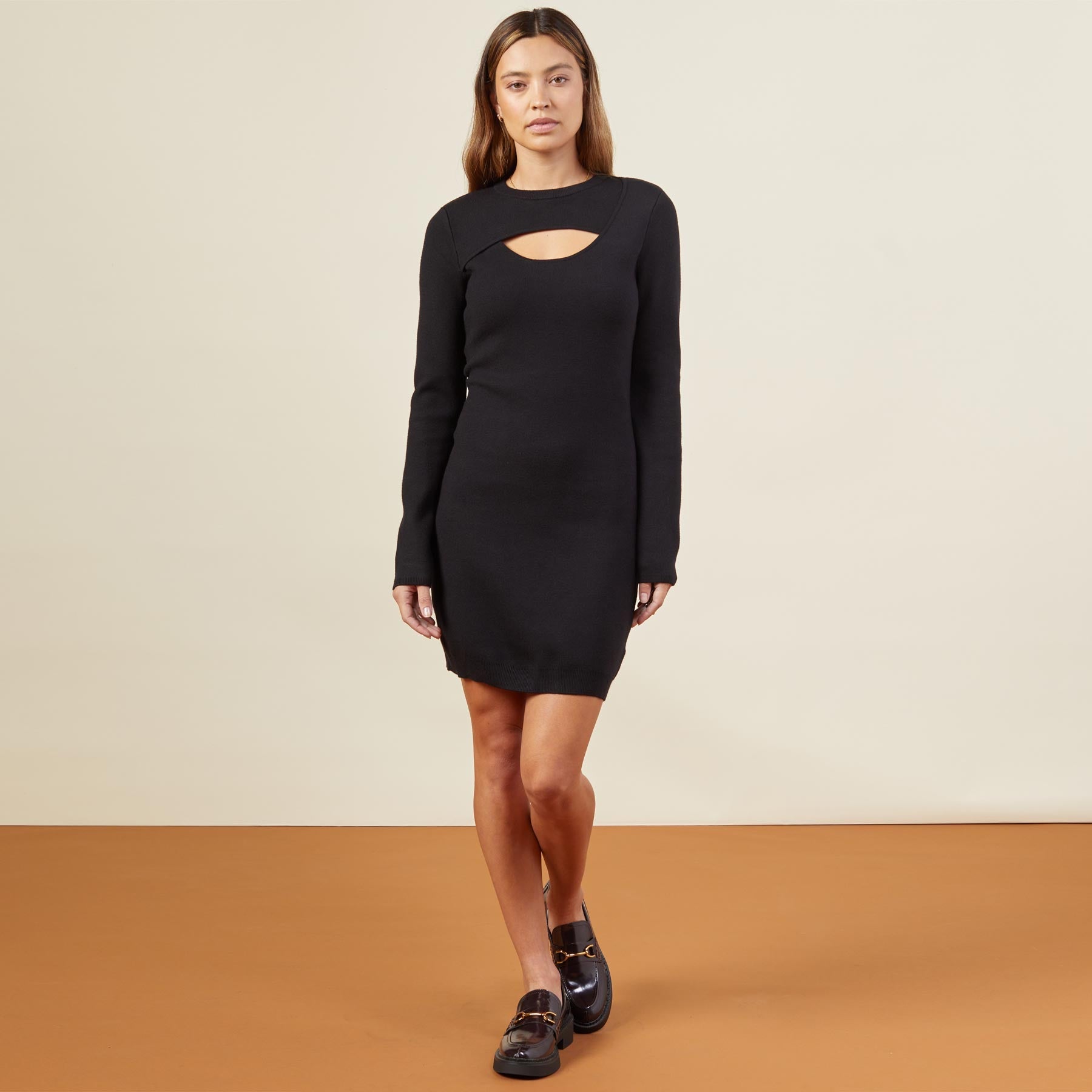 Front view of model wearing the supersoft sweater knit cut out dress in black.