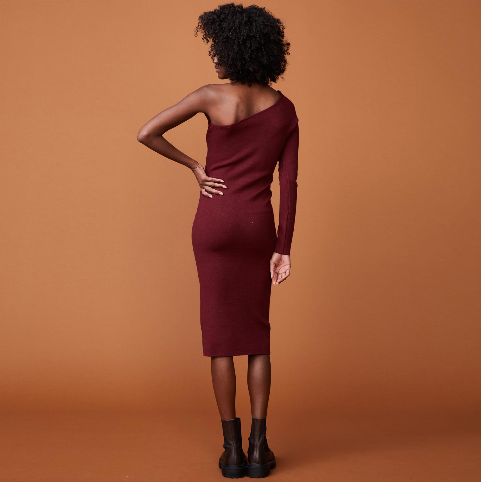 Back view of model wearing the supersoft sweater knit one shoulder dress in rhubarb.