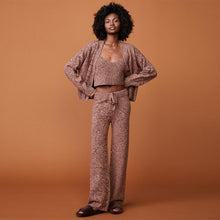 Front view of model wearing the marled oversized cardigan in pomegranate.