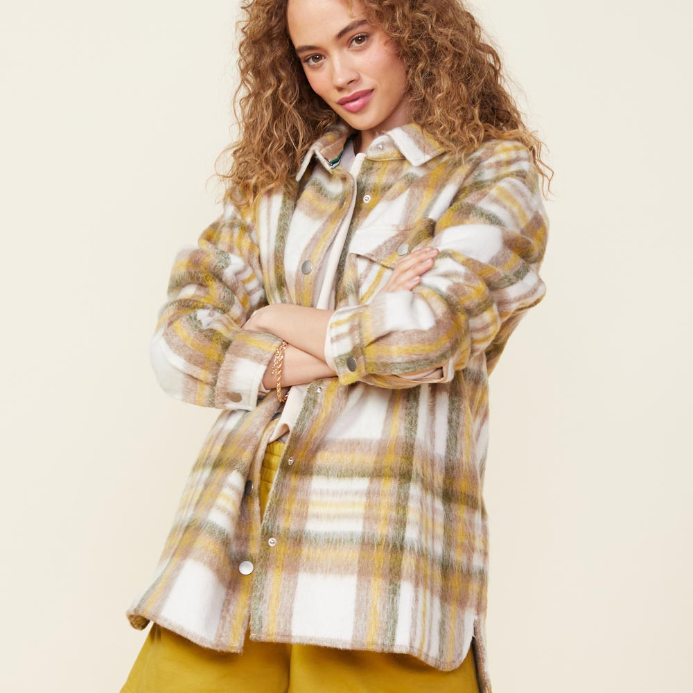 Front view of model wearing the plaid flannel jacket in multi color.