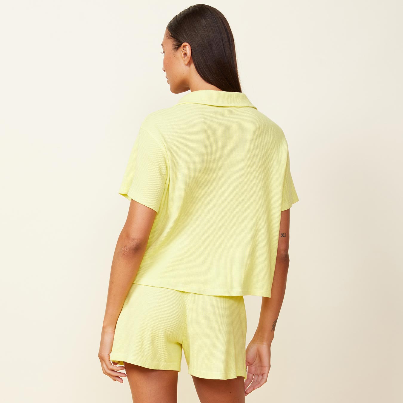 Back view of model wearing the baby thermal vacation shirt in citron.