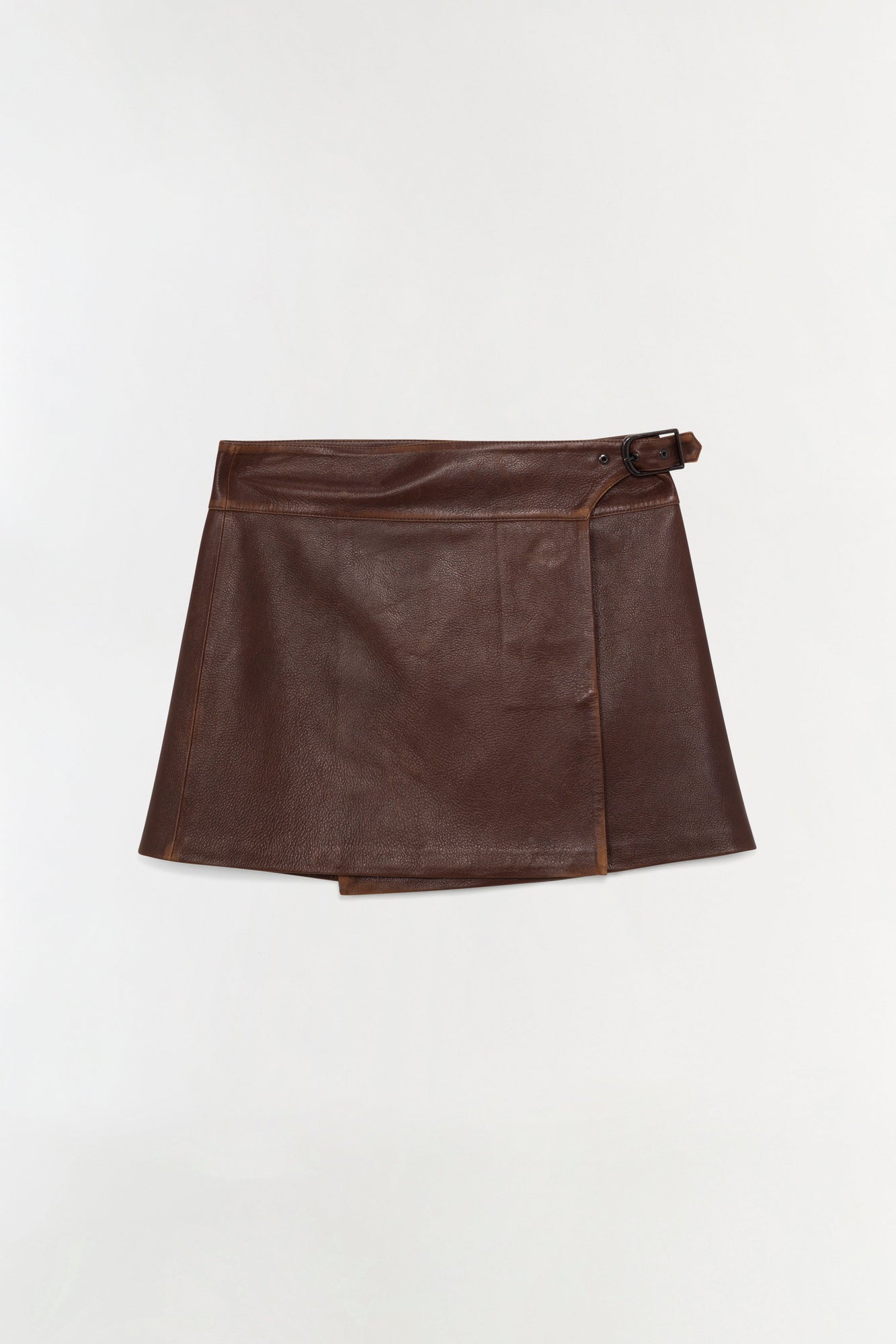 Brown leather mini skirt with wrap-front design and buckle closure at waist.